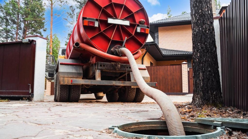 Sewer jetting truck clearing a root-blocked sewer line at an Arizona home